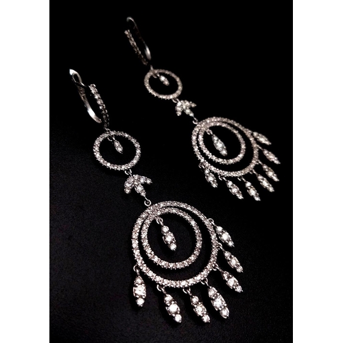 764 - A pair of Art Deco Style Pair of 18K White Gold and Diamond Drop Earrings. A multitude of diamond en... 