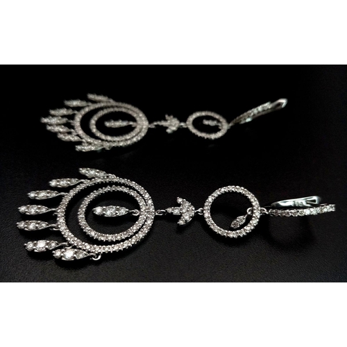 764 - A pair of Art Deco Style Pair of 18K White Gold and Diamond Drop Earrings. A multitude of diamond en... 