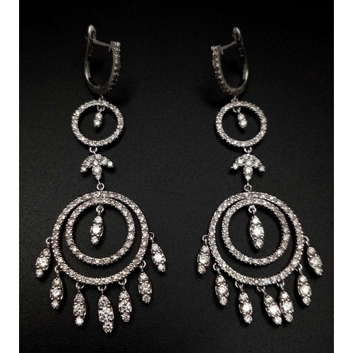 764 - A pair of Art Deco Style Pair of 18K White Gold and Diamond Drop Earrings. A multitude of diamond en... 