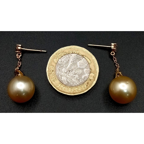 771 - A Pair of Golden South Sea Pearl and Diamond Earrings. Set in 18k Gold. Pearl - 12mm. Diamonds, pear... 