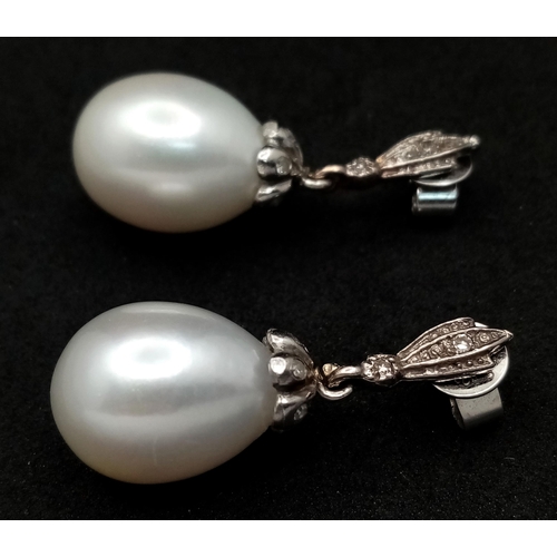 463 - A Pair of Vintage 18K White Gold, Diamond and Pearl Earrings. Large 15mm oval pearls. 8.1g total wei... 