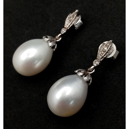 463 - A Pair of Vintage 18K White Gold, Diamond and Pearl Earrings. Large 15mm oval pearls. 8.1g total wei... 