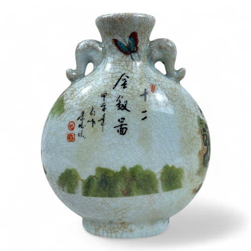 1170 - An antique Chinese Famille Rose Crackle-Glaze Vase. 
Crackled porcelain exterior featuring colorful ... 