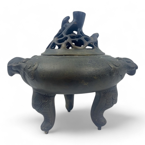 932 - An antique Chinese Bronze Tripod Censer with Pierced Lid. Engraved floral patterns, supported by thr... 