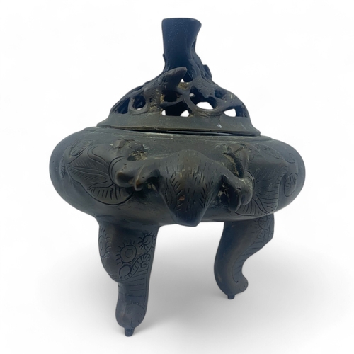 932 - An antique Chinese Bronze Tripod Censer with Pierced Lid. Engraved floral patterns, supported by thr... 