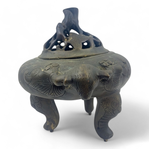 932 - An antique Chinese Bronze Tripod Censer with Pierced Lid. Engraved floral patterns, supported by thr... 