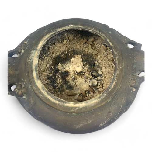 932 - An antique Chinese Bronze Tripod Censer with Pierced Lid. Engraved floral patterns, supported by thr... 