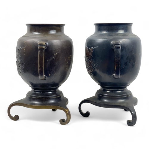 953 - A Pair of Antique Japanese Bronze Urns.
Intricate engraved landscape motifs and tripod bases. Includ... 