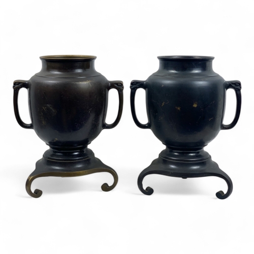 953 - A Pair of Antique Japanese Bronze Urns.
Intricate engraved landscape motifs and tripod bases. Includ... 