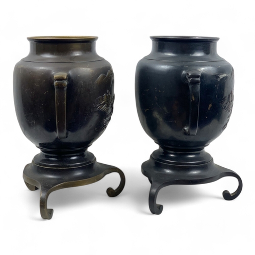 953 - A Pair of Antique Japanese Bronze Urns.
Intricate engraved landscape motifs and tripod bases. Includ... 