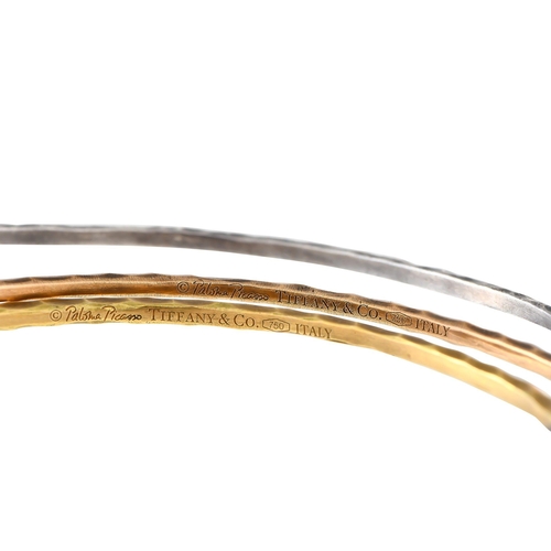 496 - A Tiffany & Co. 18K Yellow Gold, White Gold, Rose Gold Tricolor Bangle Set.This set of tricolor brac... 