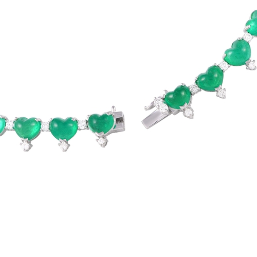 67 - A Platinum 5.84ct Diamond and Emerald Heart Necklace. Heart-shaped emerald gemstones totaling 70.9 c... 