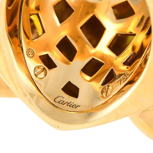 74 - An iconic Cartier Panthere 18K Yellow Gold Lacquer Ring. Black lacquer accents and green gemstone ey... 