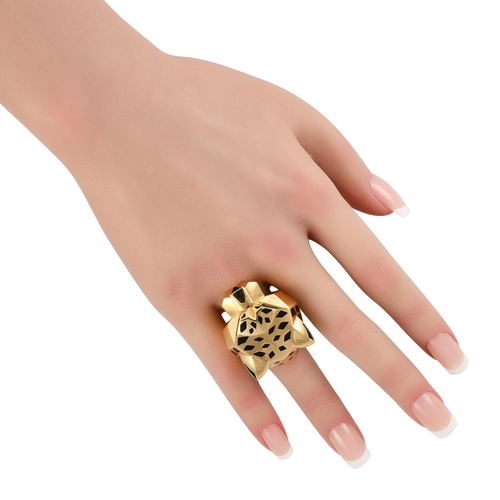 74 - An iconic Cartier Panthere 18K Yellow Gold Lacquer Ring. Black lacquer accents and green gemstone ey... 