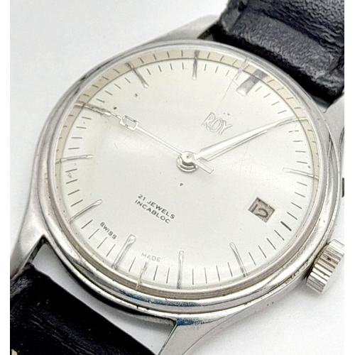 954 - An Early Swiss Made Roy Watch. 35mm case. White dial with date box. Black leather strap (could do wi... 