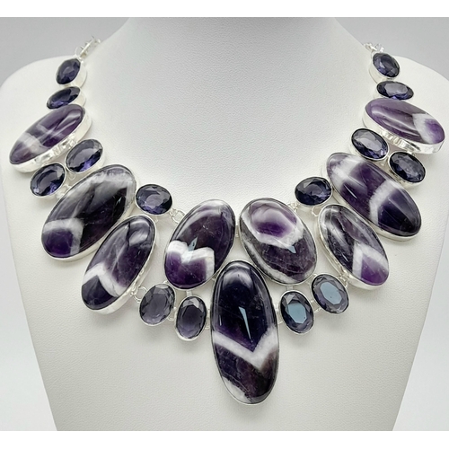 293 - An exquisite white metal (untested) amethyst necklace carrying large cabochons with the rarely seen ... 