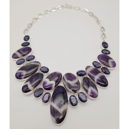 293 - An exquisite white metal (untested) amethyst necklace carrying large cabochons with the rarely seen ... 