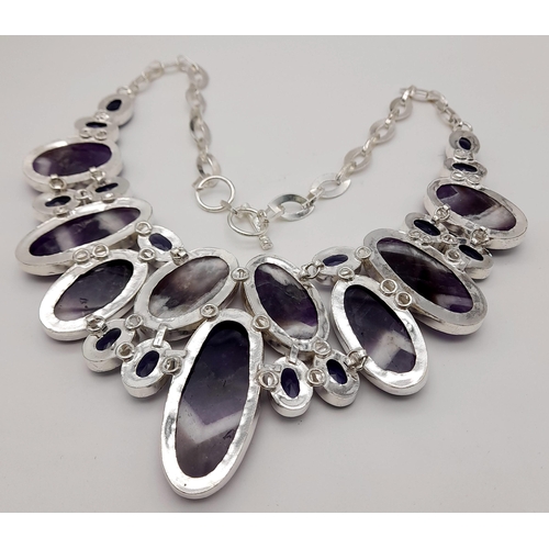 293 - An exquisite white metal (untested) amethyst necklace carrying large cabochons with the rarely seen ... 