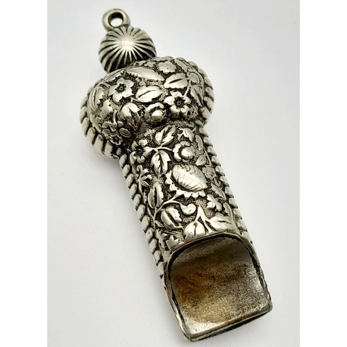 549 - A Rare Antique Georgian/Victorian Silver Whistle Pendant. Embossed floral decoration. 5cm. 19.5g