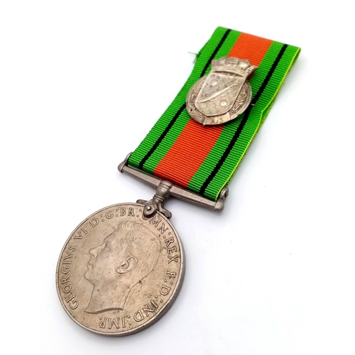 673 - A WW2 British Defence Medal with a Silver Royal Navy Patrol Pin. The pin was normally given to Briti... 