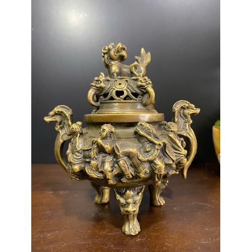 1306 - An antique Chinese Bronze Tripod Censer with Lid. Detailed hand carved figures of dragons, and foo d... 