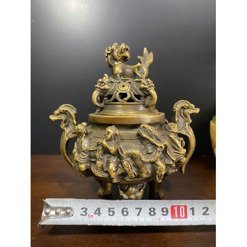 1306 - An antique Chinese Bronze Tripod Censer with Lid. Detailed hand carved figures of dragons, and foo d... 