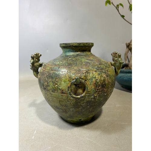 935 - An antique Oriental Bronze Ritual Vessel with Inscribed Exterior. Patinated bronze exterior with lio... 