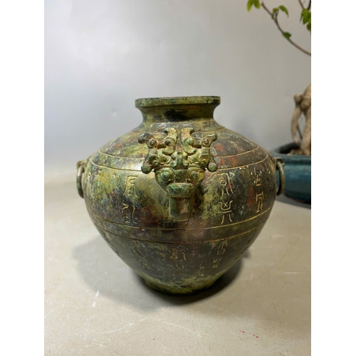 935 - An antique Oriental Bronze Ritual Vessel with Inscribed Exterior. Patinated bronze exterior with lio... 