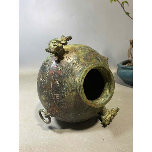 935 - An antique Oriental Bronze Ritual Vessel with Inscribed Exterior. Patinated bronze exterior with lio... 