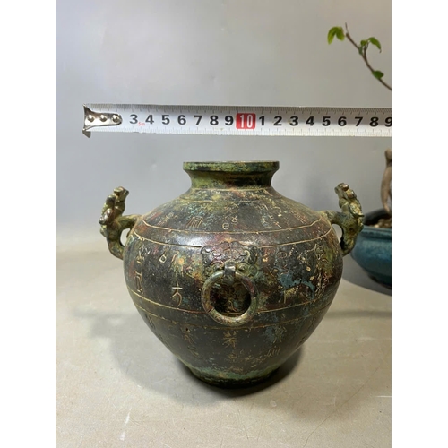 935 - An antique Oriental Bronze Ritual Vessel with Inscribed Exterior. Patinated bronze exterior with lio... 