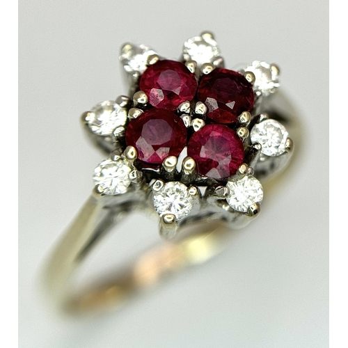 1148 - An 18K Yellow Gold Ruby and Diamond Ring. Brilliant cuts in floral form. 040ctw diamonds. 0.40ctw ru... 