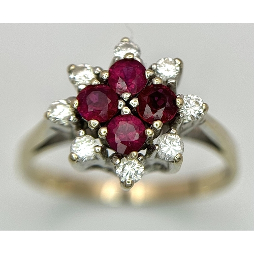 1148 - An 18K Yellow Gold Ruby and Diamond Ring. Brilliant cuts in floral form. 040ctw diamonds. 0.40ctw ru... 