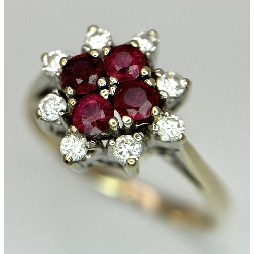 1148 - An 18K Yellow Gold Ruby and Diamond Ring. Brilliant cuts in floral form. 040ctw diamonds. 0.40ctw ru... 