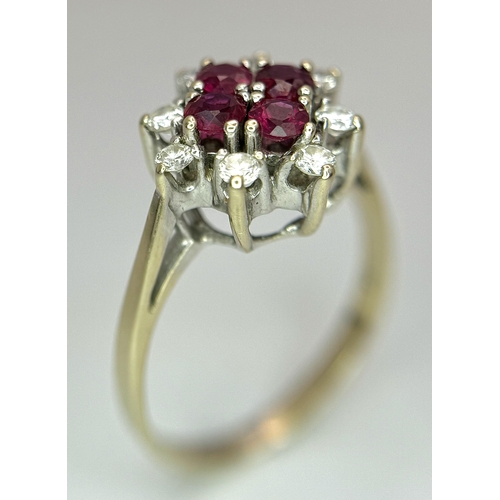 1148 - An 18K Yellow Gold Ruby and Diamond Ring. Brilliant cuts in floral form. 040ctw diamonds. 0.40ctw ru... 