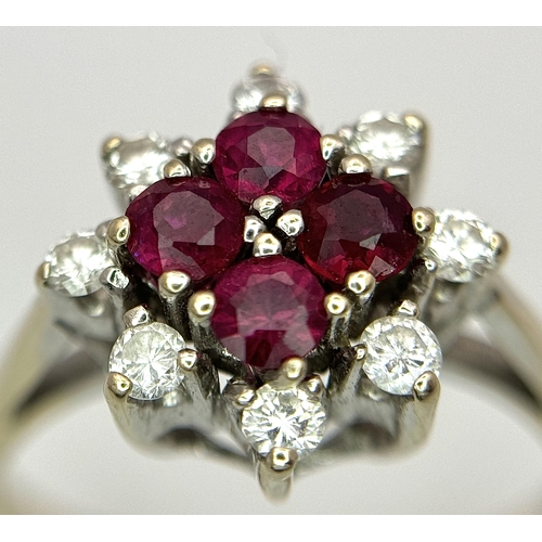 1148 - An 18K Yellow Gold Ruby and Diamond Ring. Brilliant cuts in floral form. 040ctw diamonds. 0.40ctw ru... 