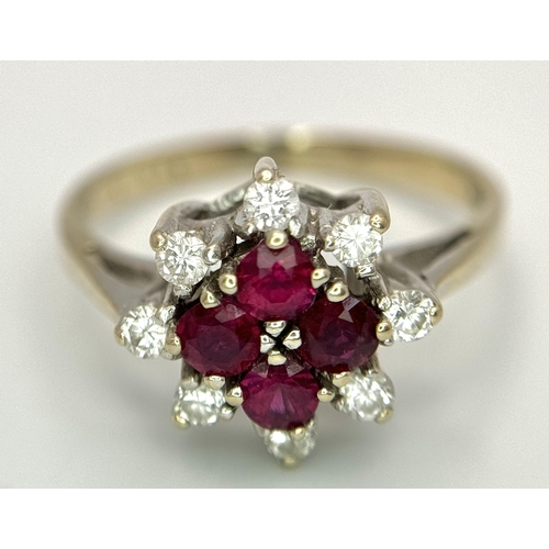 1148 - An 18K Yellow Gold Ruby and Diamond Ring. Brilliant cuts in floral form. 040ctw diamonds. 0.40ctw ru... 