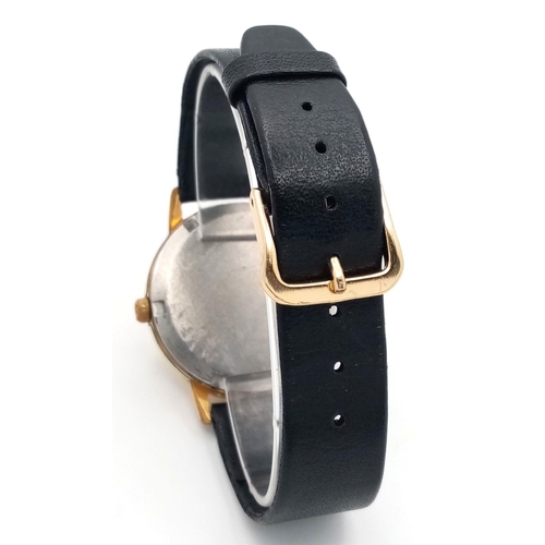 1169 - A Vintage Omega Geneve Mechanical Gents Watch. Black leather strap. Gilded case - 35mm. Hand-wind. P... 