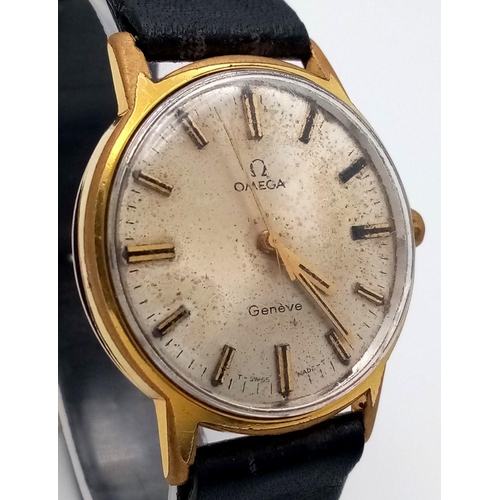 1169 - A Vintage Omega Geneve Mechanical Gents Watch. Black leather strap. Gilded case - 35mm. Hand-wind. P... 