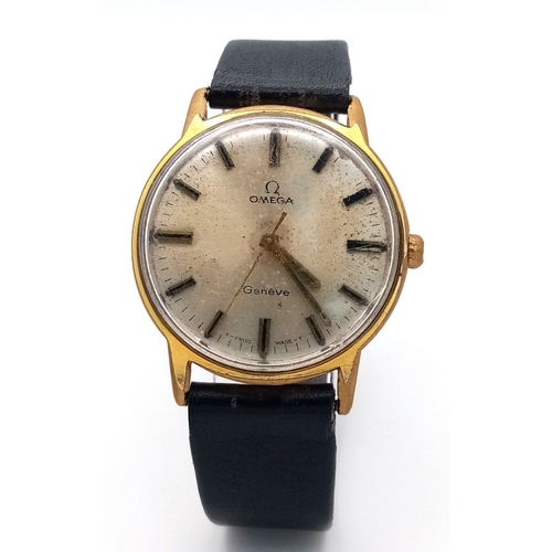 1169 - A Vintage Omega Geneve Mechanical Gents Watch. Black leather strap. Gilded case - 35mm. Hand-wind. P... 