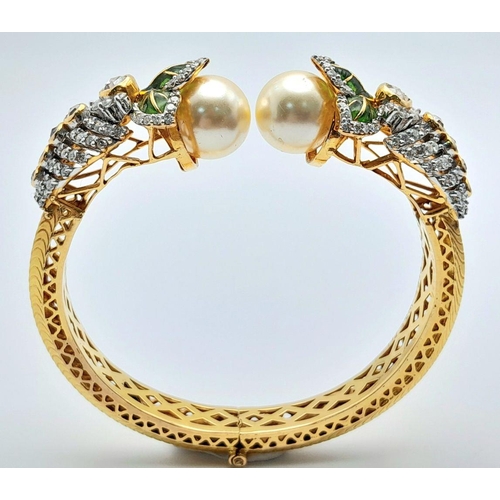 650 - A Stunning, Head-Turning 18K Yellow Gold, Diamond and Pearl Bangle. Serpentine in nature, this eclec... 