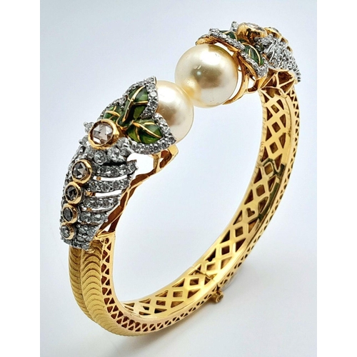 650 - A Stunning, Head-Turning 18K Yellow Gold, Diamond and Pearl Bangle. Serpentine in nature, this eclec... 