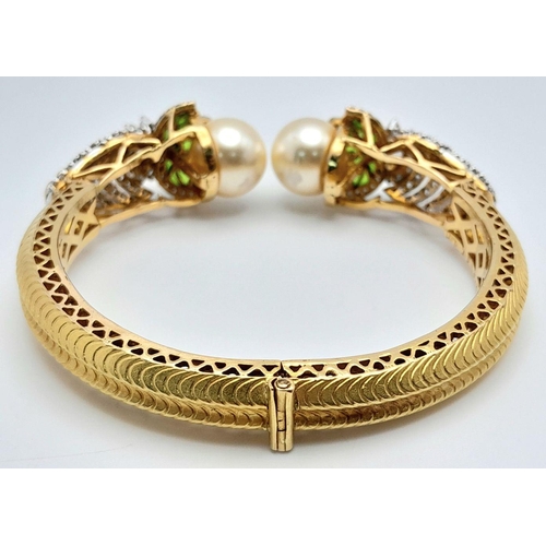 650 - A Stunning, Head-Turning 18K Yellow Gold, Diamond and Pearl Bangle. Serpentine in nature, this eclec... 