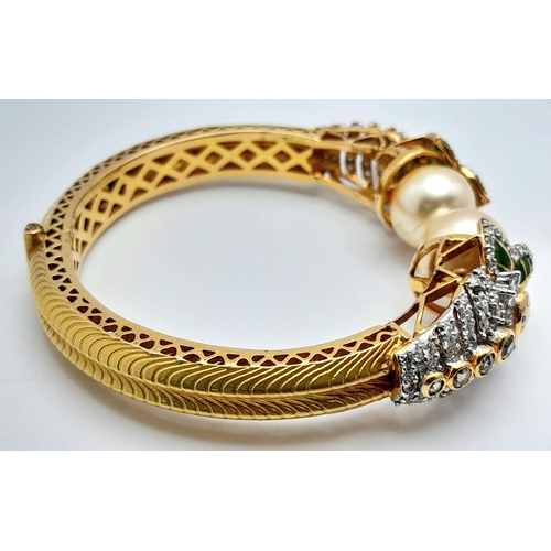 650 - A Stunning, Head-Turning 18K Yellow Gold, Diamond and Pearl Bangle. Serpentine in nature, this eclec... 