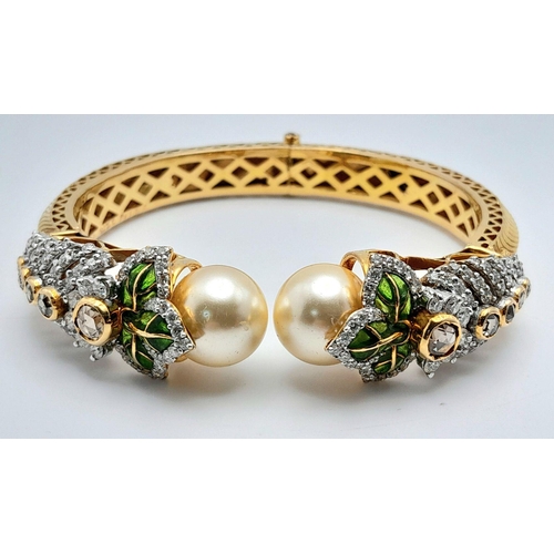 650 - A Stunning, Head-Turning 18K Yellow Gold, Diamond and Pearl Bangle. Serpentine in nature, this eclec... 