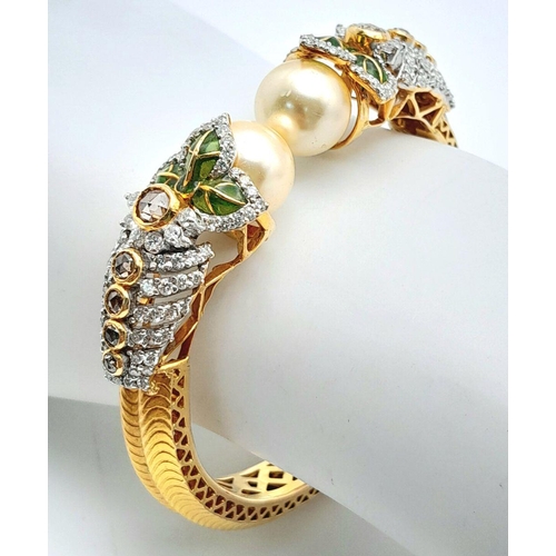 650 - A Stunning, Head-Turning 18K Yellow Gold, Diamond and Pearl Bangle. Serpentine in nature, this eclec... 