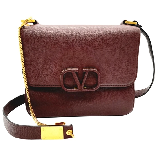 152 - A Valentino Garavani Burgundy Leather Shoulder Bag. Burgundy leather exterior with gold-toned hardwa... 