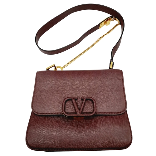 152 - A Valentino Garavani Burgundy Leather Shoulder Bag. Burgundy leather exterior with gold-toned hardwa... 