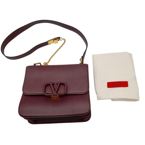 152 - A Valentino Garavani Burgundy Leather Shoulder Bag. Burgundy leather exterior with gold-toned hardwa... 