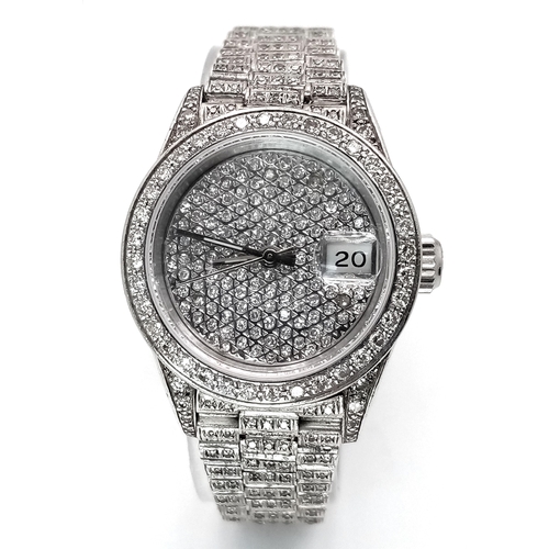 153 - An 18 K white gold, ladies ROLEX DATEJUST OYSTER PERPETUAL watch, covered with round cut diamonds th... 