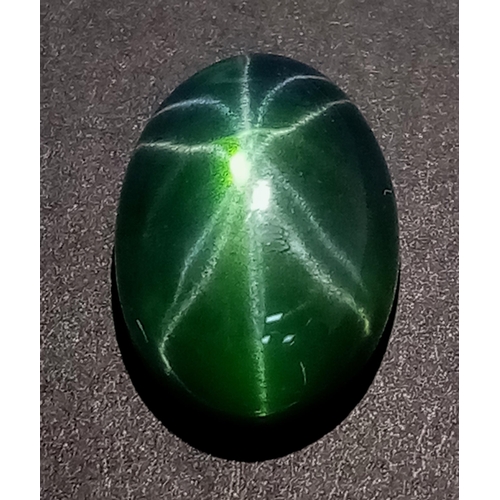 174 - An extremely rare, six-ray, GREEN STAR SAPPHIRE! The oval cabochon has a weight of 9.20 carats and d... 